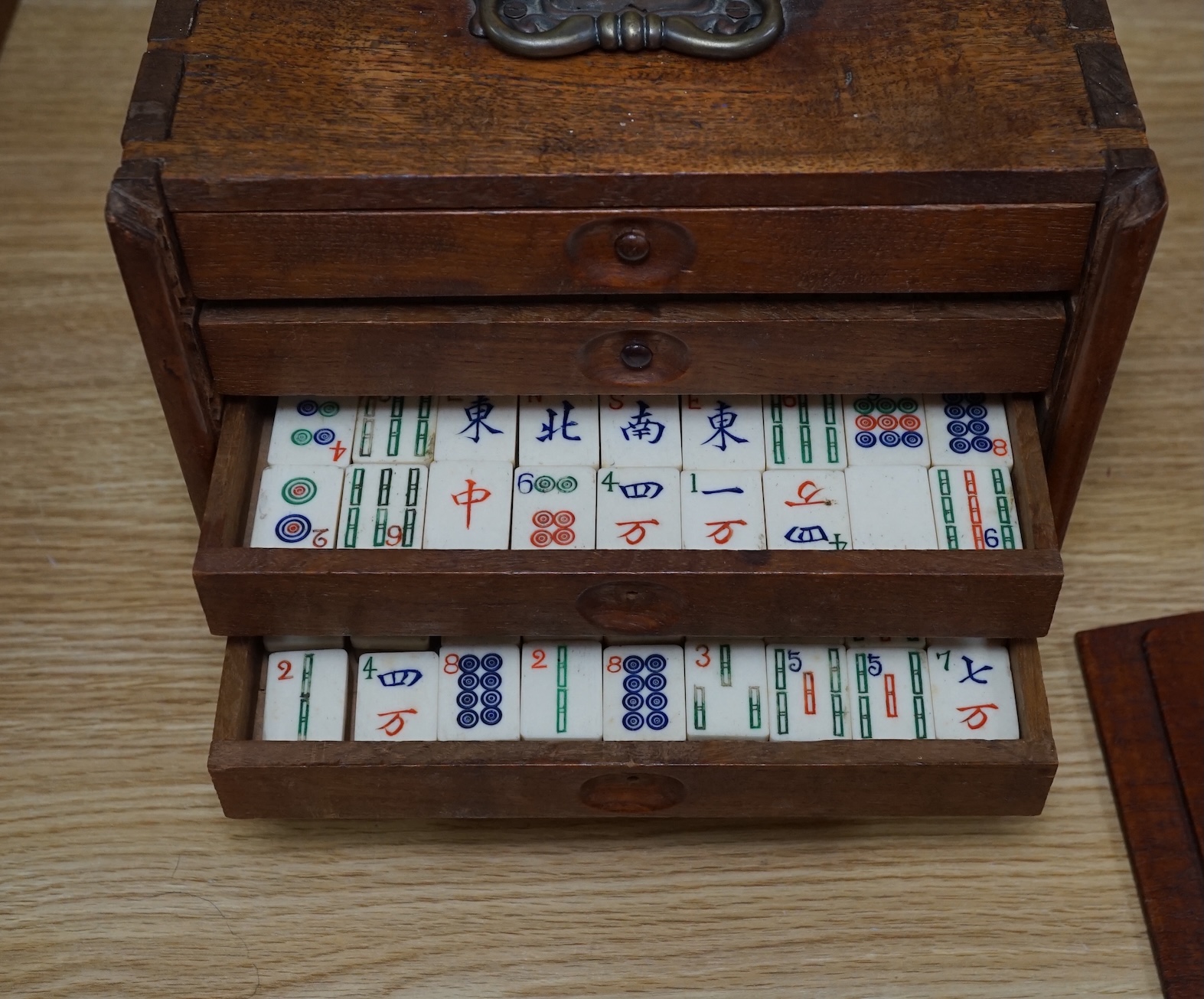 A Chinese boxed bone Mah jong set with five drawers, 19cm high. Condition - poor to fair, case damaged